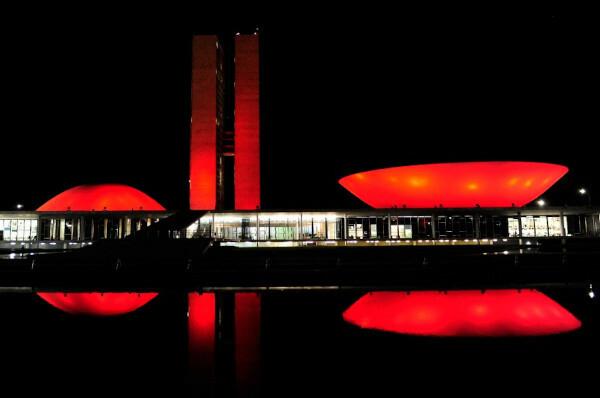 National Congress building, in Brasília, lit up in red in December, part of the Red December campaign.